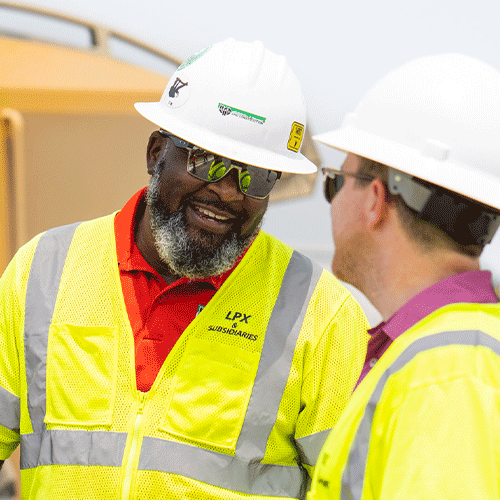 Two construction workers on a heavy civil job site have a conversation.