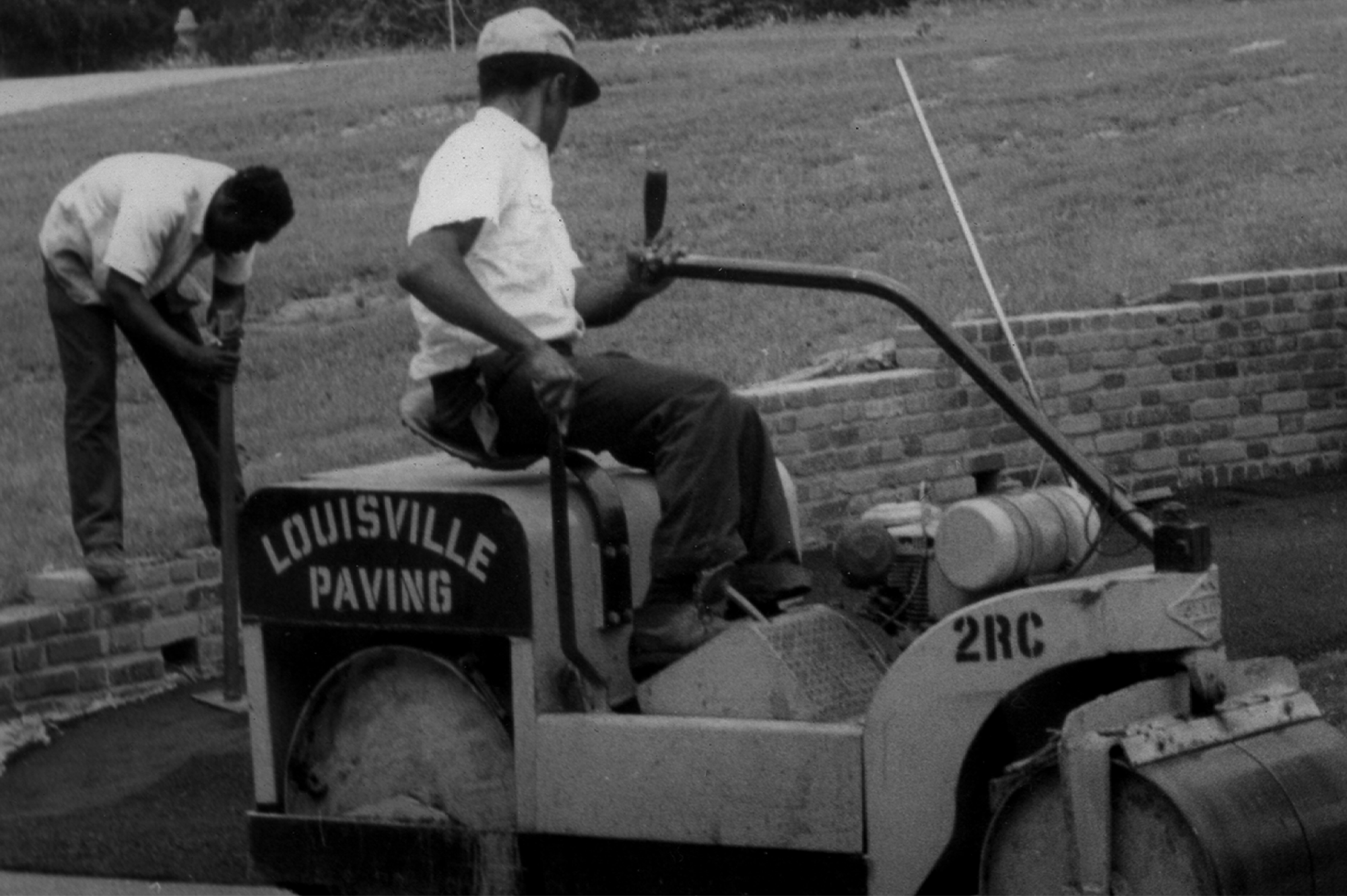 A photo of an early LPC worker on an asphalt roller in Kentuckiana.
