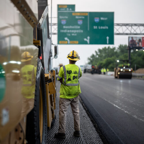 An LPC worker stands on a highway in Kentuckiana