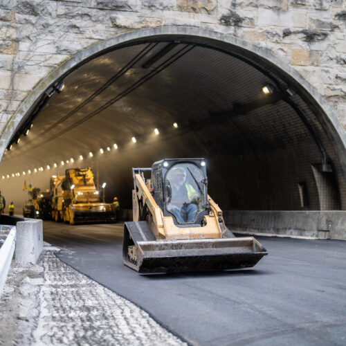 A compact track drives out of a tunnel in Kentuckiana