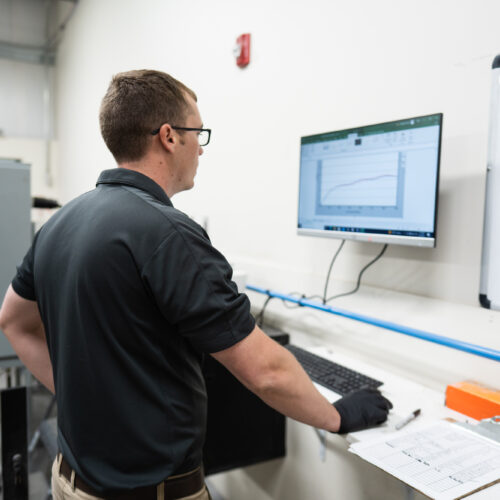 A Bluegrass Testing employee checks his computer at a material testing lab in Kentuckiana